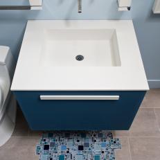 Blue Floating Vanity, Wall-Mounted Faucet and Mosaic Tile Create Watery Design Effect