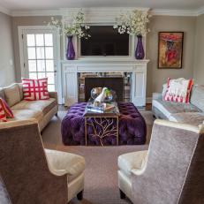 Living Room With Purple Ottoman That Serves as Coffee Table