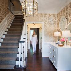 Foyer With Gold Light Fixture and Whimsical Wallpaper