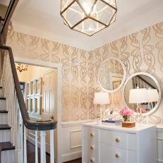 Foyer With White Dresser and Round Mirrors