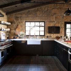Transitional Kitchen With Stone Walls and Exposed Beams