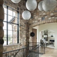 Entryway With Stone Walls & Globe Pendant Lights