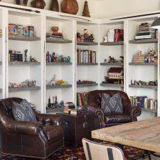 Art Studio Features Built-In Bookshelves, Leather Chairs & Patterned Rug