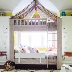 Whimsical Kids Room Features Bunk Beds With Hand Knotted Yarn Canopy
