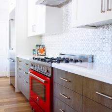 Lovely Galley Kitchen Features Bold Red Oven
