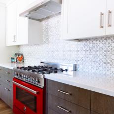 Galley Kitchen Features Contrasting Upper & Lower Cabinets and Bright Red Oven