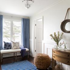 Blue and White Colonial Hall With Bench