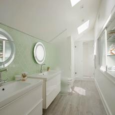 Green and White Bathroom With Skylights