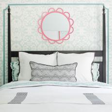 Black Four-Poster Bed and Pink Mirror