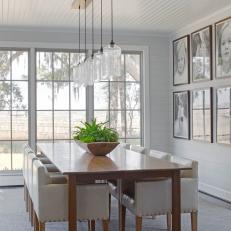 Neutral Transitional Dining Room With Glass Pendants