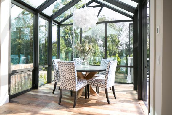 Dining Area With Glass Walls, Bubble Chandelier & Round Table