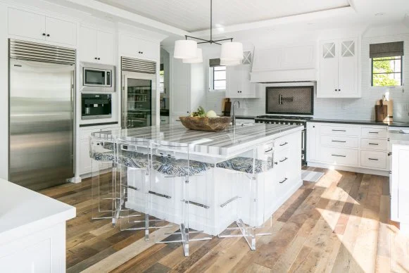Kitchen With White Cabinets, White Island and Acrylic Barstools