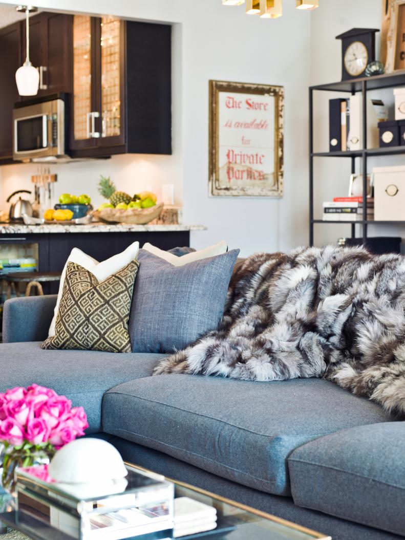 Condo Living Room With Blue Sofa and Faux Fur Blanket