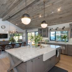 Large Transitional Kitchen With Natural Wood Roof, Large Island, Gray Cabinetry and White Marble Countertop 