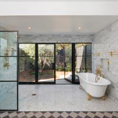 Giant Open Transitional Shower and Bath Space With Gray Marble TIle Walls, Claw Foot Bathtub and Gold Faucets and Nozzles