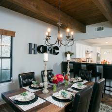 Charming Traditional Open Dining Room With Decorative Table Setting, Leather Dining Chairs and Simple Chandelier