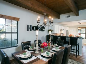 Charming Traditional Open Dining Room With Decorative Table Setting, Leather Dining Chairs and Simple Chandelier