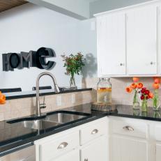 Traditional Kitchen Details Featuring Painted White Cabinets, Natural Stone Backsplash and Granite Countertops