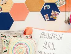 Colorful Dorm Room Bed Decor Featuring Painted Hexagon Cork Boards Over Layered Throw Pillows 