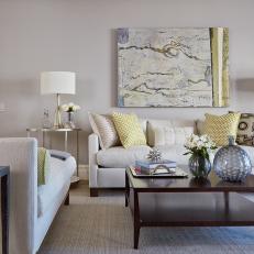 Transitional Living Room With Neutral Sofa and Chaise Around Square Wood Coffee Table and Metallic Decorative Accents 