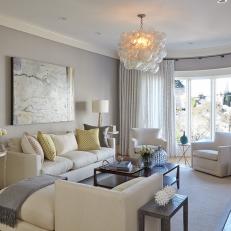 Sophisticated, Chic Transitional Living Room With Neutral Tones, Bubble Light Fixture and Bay Window 