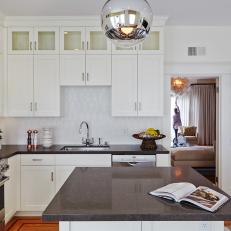 Spacious, Transitional Kitchen With White Cabinetry, Patterned White Backsplash and Gray Stone Countertop 