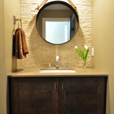 Powder Room With Textured Accent Wall & Circular Mirror