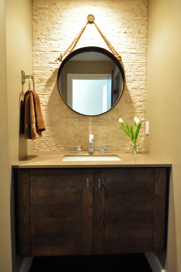 Powder Room With Textured Accent Wall & Circular Mirror | HGTV