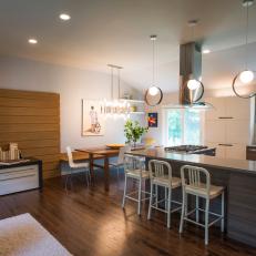 Gorgeous, Smooth Design in Open Contemporary Kitchen Featuring Woodgrain Eat-In Island, Pendant Lighting and Neutral Tones