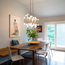 Contemporary Dining Room With Long Wood Table, White Chairs and Floating Bench and Multi-Bulb Light Fixture
