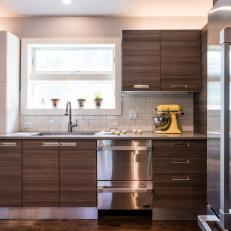 Bright, Contemporary Kitchen With Woodgrain Cabinets, Stainless Steel Appliances and White Tile Backsplash