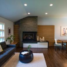 Contemporary Open Floor Plan Living Room With Brown Tufted Sofa and Natural Rock Fireplace Surround 