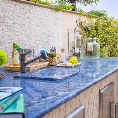 Rough Tile Outdoor Kitchen With Smooth Blue Marble Countertop and Built in Sink 