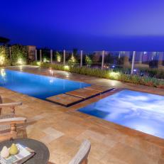 Marble Tile Pool Deck With Glass Retaining Wall, In-Water Walkway and Outdoor Seating