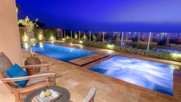 Marble Tile Pool Deck With Glass Retaining Wall In Water
