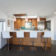 Midcentury Modern Kitchen Woodgrain Island and Cabinets, White Bar Chairs and Countertop and Geometric Pendant Lights