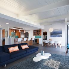 Navy Blue Sofa in Open Floor Plan Modern Living Room With Exposed Ceiling Beams and Blue Accents