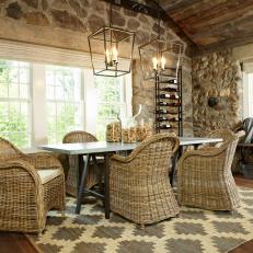 Stone Dining Room With Wicker Chairs and Large Lanterns