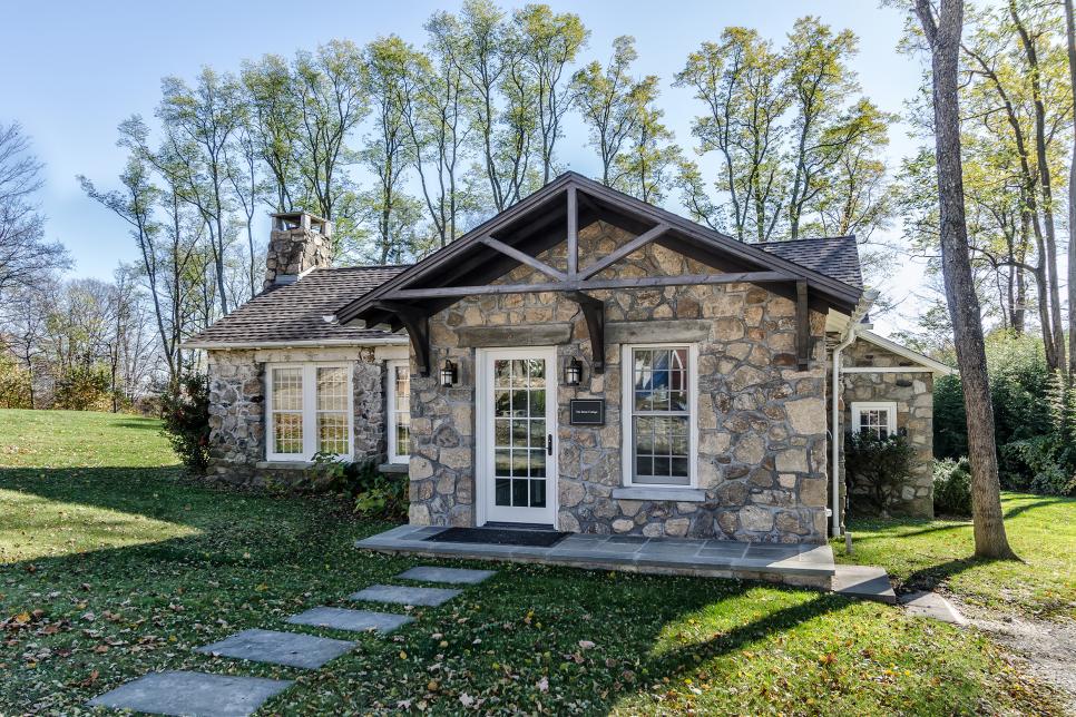 Gray Stone House With Small Slate Porch and Many Windows