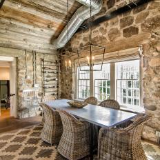 Stone-Walled Dining Room With High Wood Ceilings