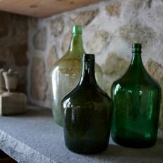 Bluestone Shelf Holding Vintage Green Glass Bottles