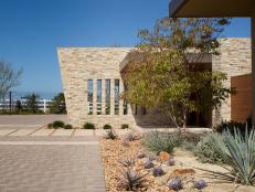 Southwestern Home Exterior With Stacked Stone Walls, Desert Landscape
