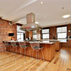 Loft Kitchen With Exposed Brick Walls & Hardwood Floors