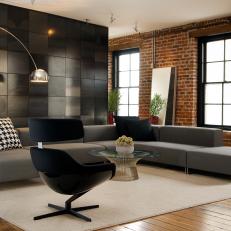 Loft Living Area Features Mod Gray Sectional & Exposed Brick Walls