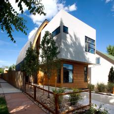 Exterior of a Modern Home Featuring Wood Siding, White Stucco and Curved Ceiling