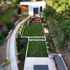 Eclectic Backyard Plot with Deck, Flower Beds and Tiered Grass Lawn Areas