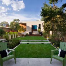 Backyard with Concrete Patio, Tiered Lawn Area, Trees and Potted Plants