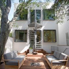 Rear Facade of a Two-Story Home Features Spiral Staircase