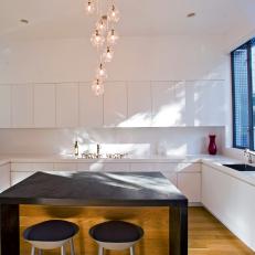 Modern Kitchen With White Cabinets & Custom Wood Island