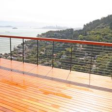 Balcony With Custom Railing Overlooking Green Hills and Water